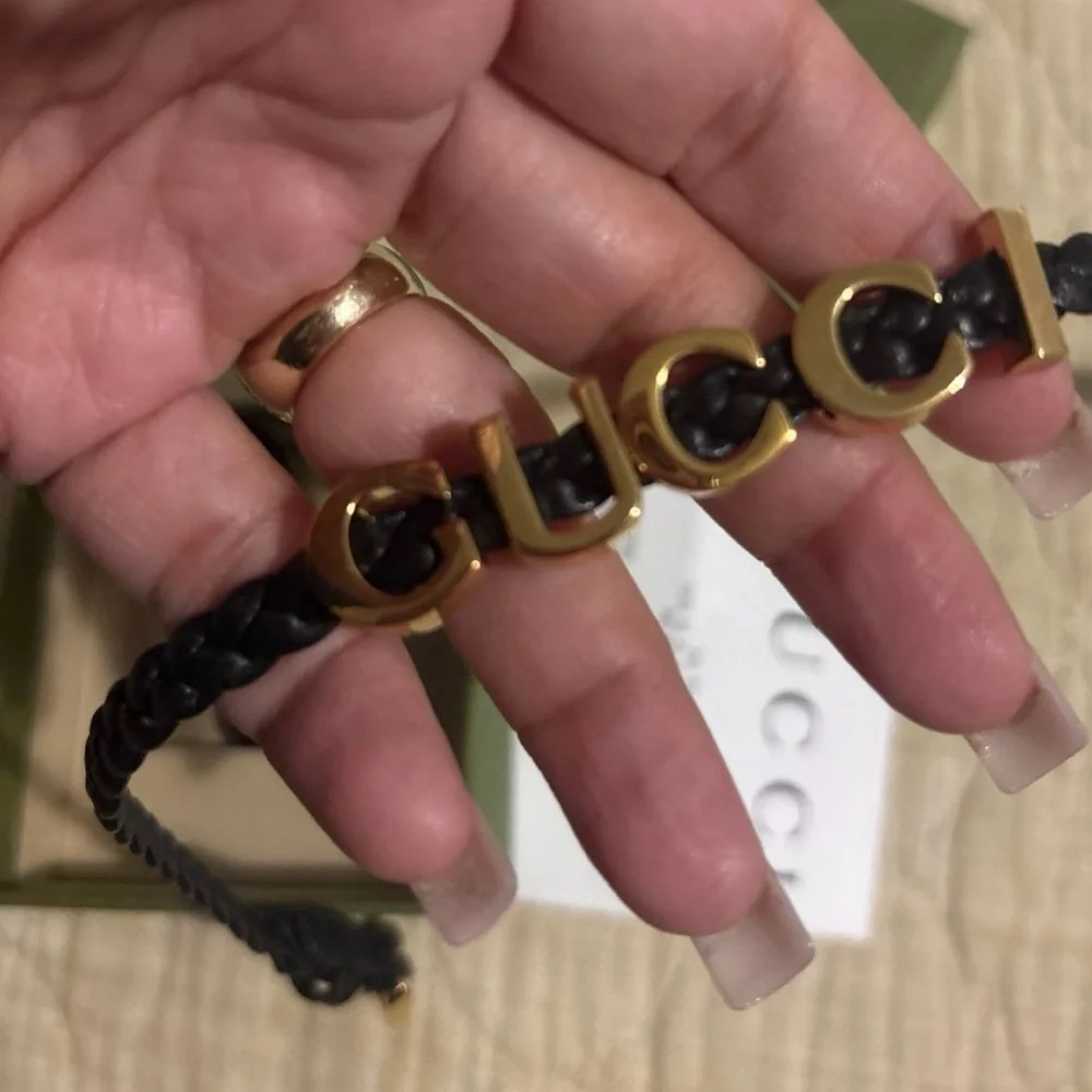 Gucci Black and Gold Logo double strap bracelet .